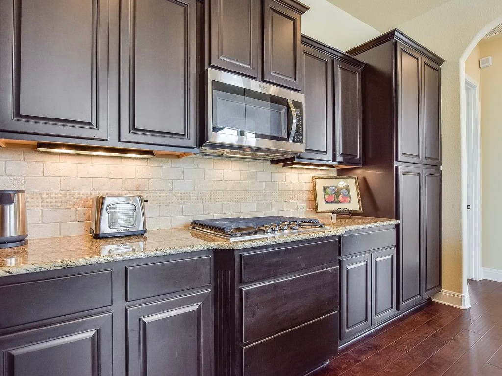 106 Evolutions Path Austin, TX 78738 - Photo 6 of 24 a kitchen with stainless steel appliances granite countertop a stove and a microwave