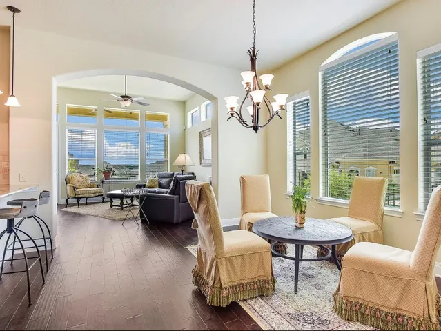 a living room with fireplace furniture and a chandelier