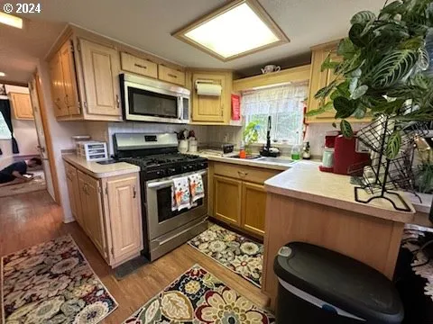 a kitchen with a stove a sink and a microwave