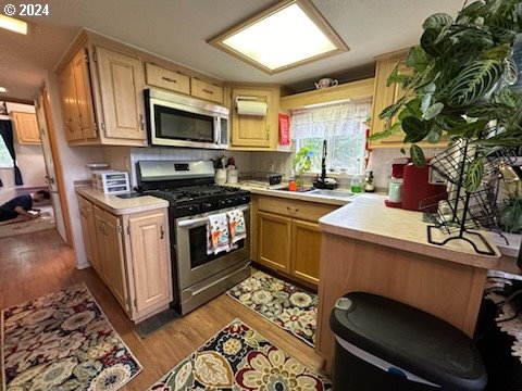 28800 Salmon River Highway Grand Ronde, OR 97347 - Photo 11 of 37 a kitchen with a stove a sink and a microwave