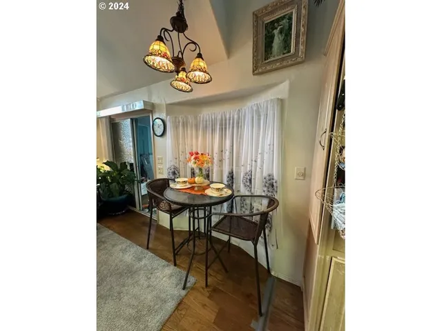 a view of a dining room with a table and chairs