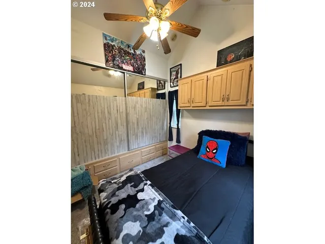 a bedroom with a bed and a chandelier