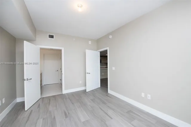 a spacious bathroom with a double vanity sink and mirror