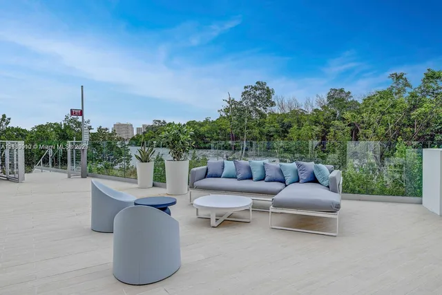 a view of a patio with chairs and a potted plant