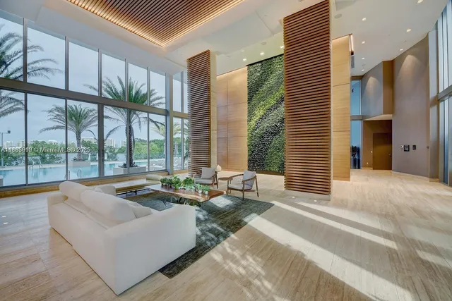 a living room with furniture and a table with potted plants