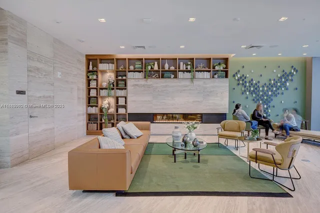a living room with furniture and a book shelf