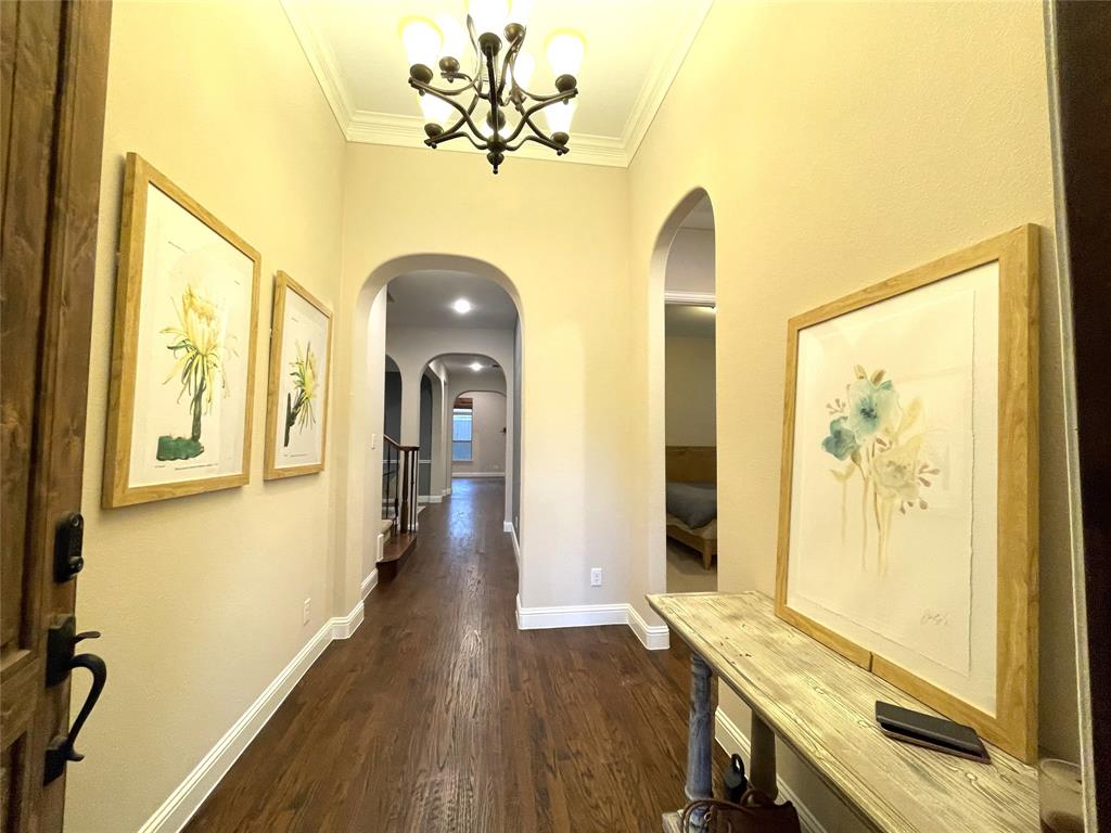 1840 Audubon Pond Way Allen, TX 75013 - Photo 4 of 38 a view of a hallway with wooden floor and a chandelier
