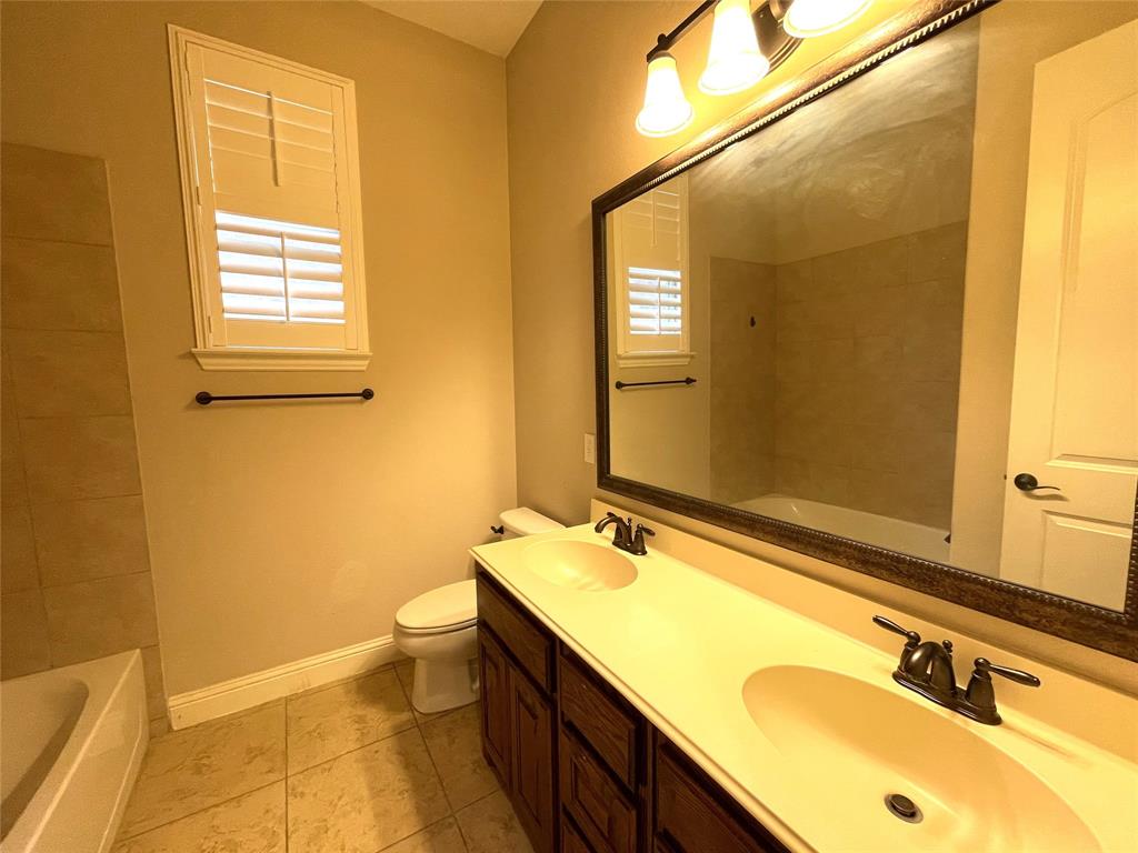 1840 Audubon Pond Way Allen, TX 75013 - Photo 6 of 38 a bathroom with a granite countertop sink mirror and a toilet