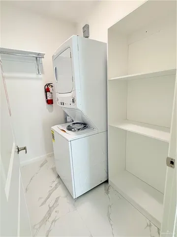 a utility room with cabinets washer and dryer