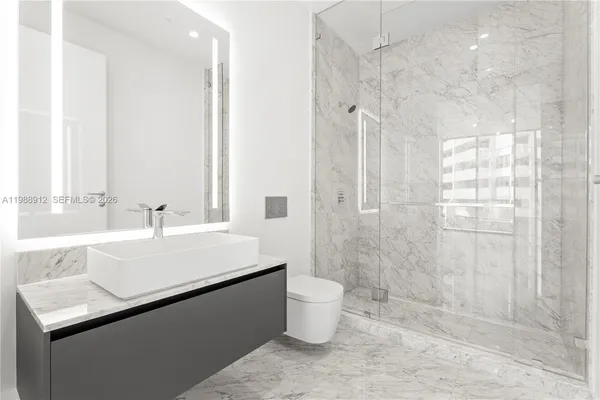 a bathroom with a double vanity sink mirror and bathtub