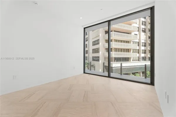 an empty room with closet and windows