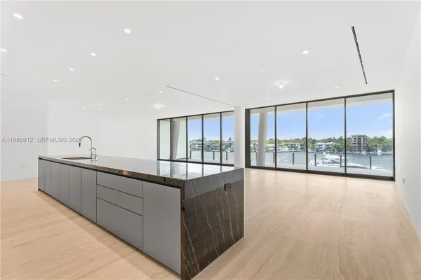 a large white kitchen with a large window