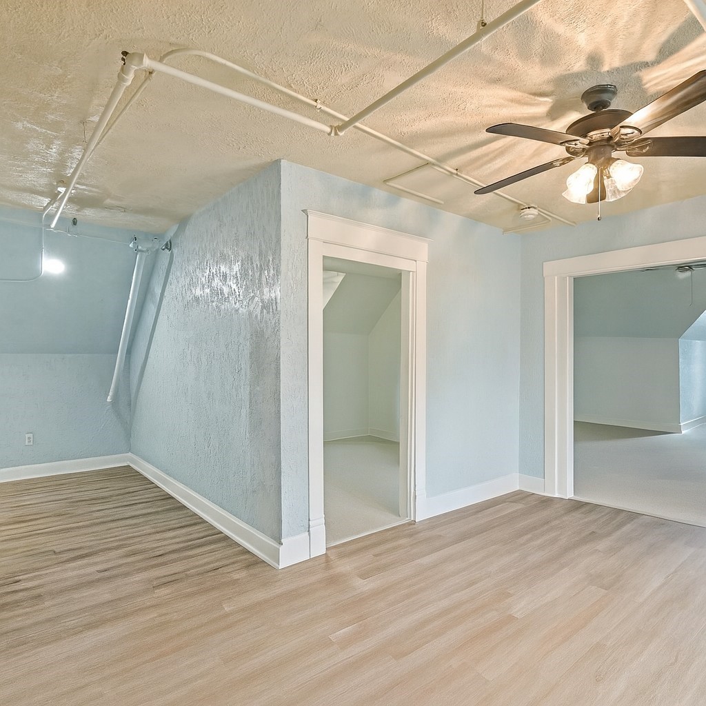1030 4th Street Rosenberg, TX 77471 - Photo 21 of 39 a view of a big room with wooden floor and fan