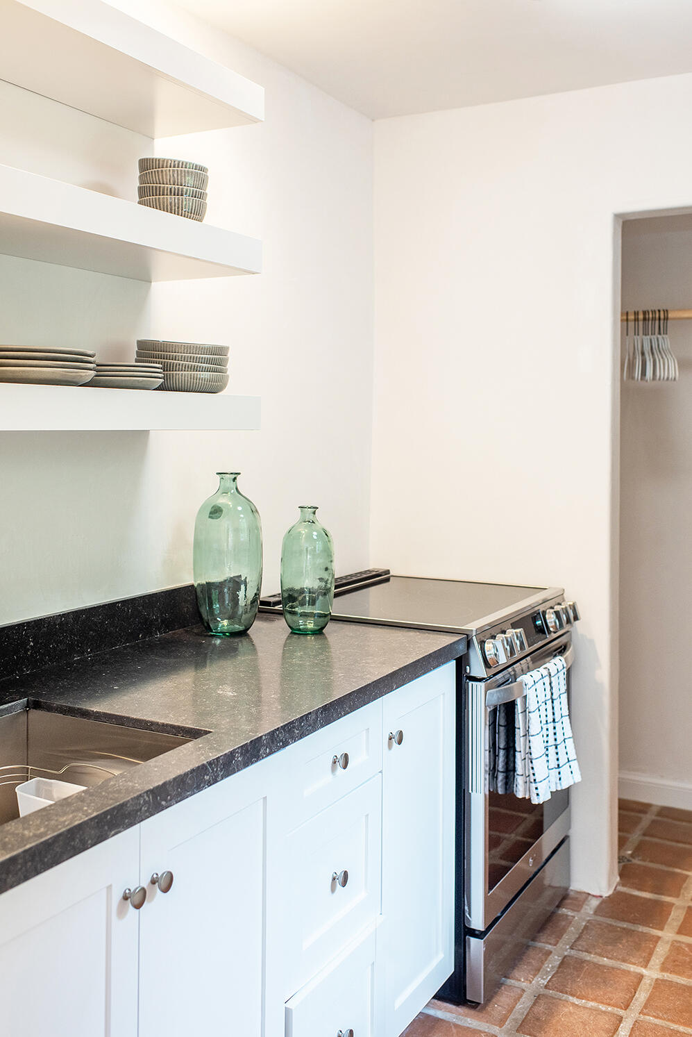 126 Loureyro Road Montecito, CA 93108 - Photo 20 of 46 a kitchen with granite countertop a white cabinets and stove