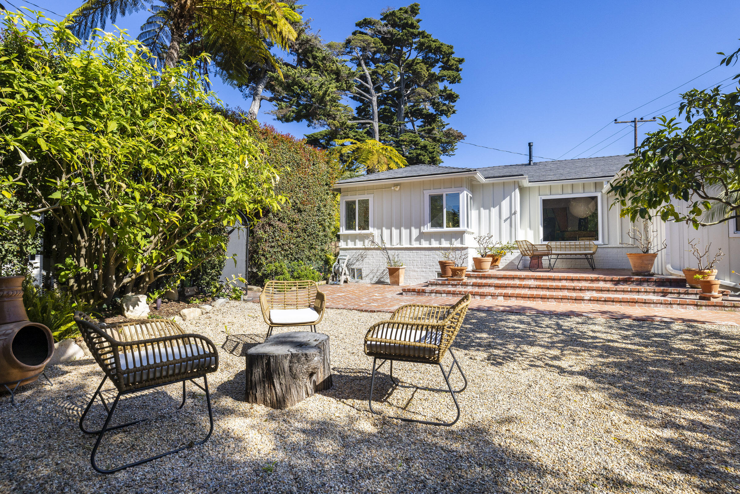 126 Loureyro Road Montecito, CA 93108 - Photo 6 of 46 a view of a patio with a dining table and chairs with a fire pit