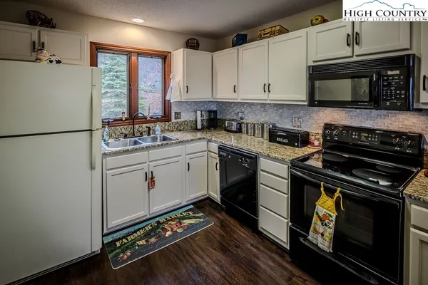 a kitchen with a stove a sink and a refrigerator