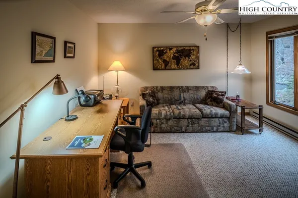 a living room with furniture and a lamp