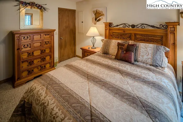 a bedroom with a bed and a closet with mirror