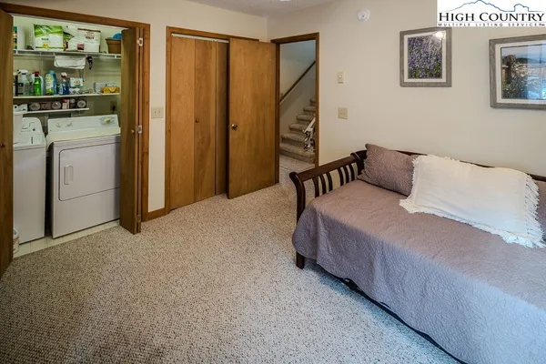 a bedroom with a bed and a mirror
