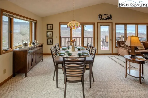 a dining room with furniture water view and a chandelier