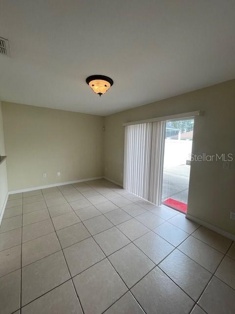 23 Ridley Lane, Unit B Palm Coast, FL 32164 - Photo 14 of 17 an empty room with floor to ceiling windows and painted walls