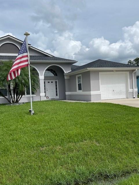 23 Ridley Lane, Unit B Palm Coast, FL 32164 - Photo 3 of 17 a front view of house with yard and green space