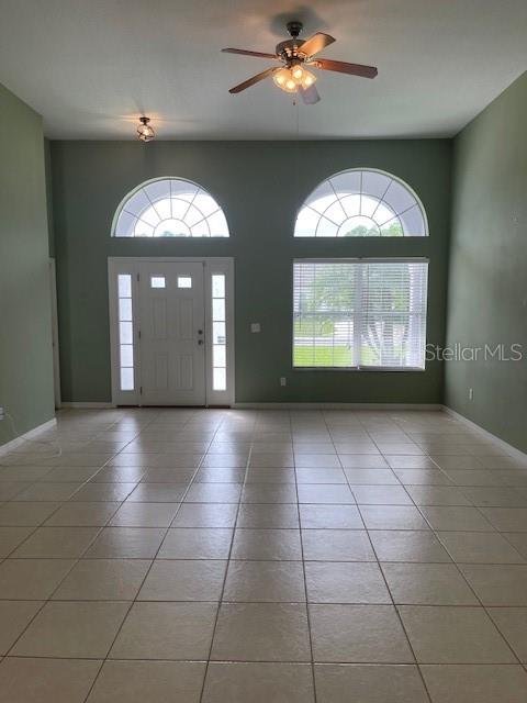23 Ridley Lane, Unit B Palm Coast, FL 32164 - Photo 4 of 17 an empty room with a chandelier fan and windows