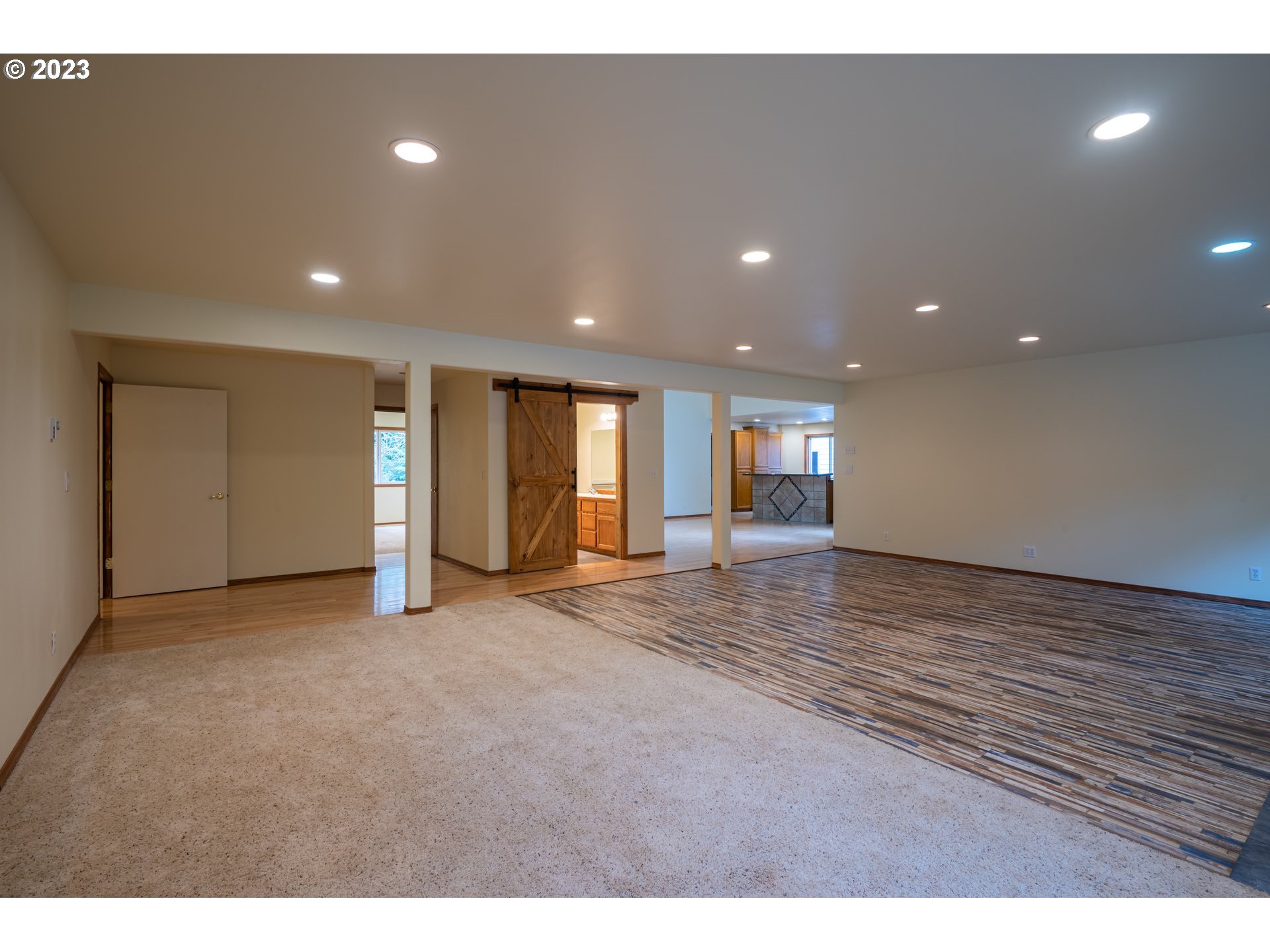 87763 Two Mile Lane Bandon, OR 97411 - Photo 13 of 41 a view of an empty room with wooden floor and windows