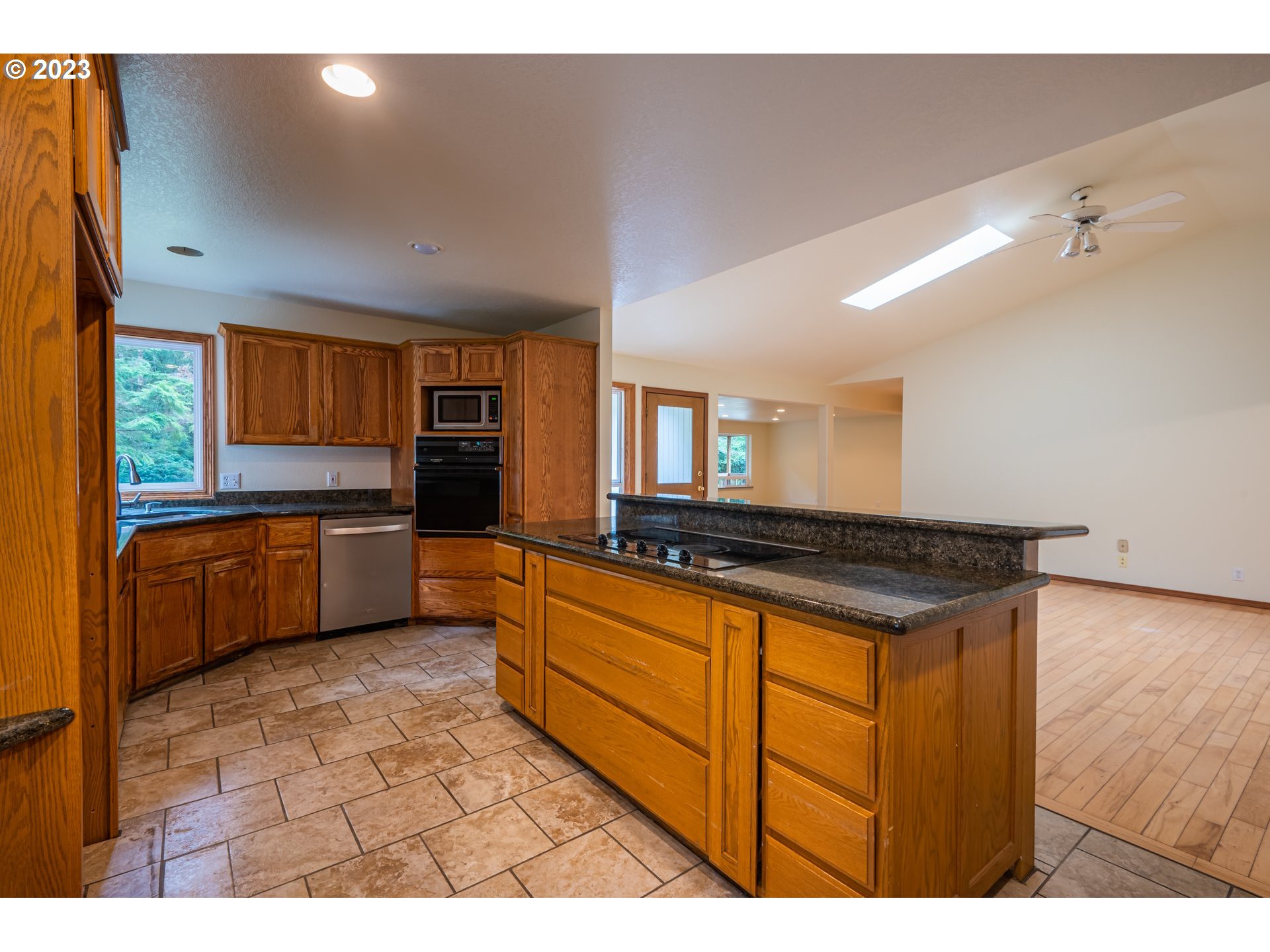 87763 Two Mile Lane Bandon, OR 97411 - Photo 17 of 41 a kitchen with stainless steel appliances granite countertop a stove a sink and a refrigerator