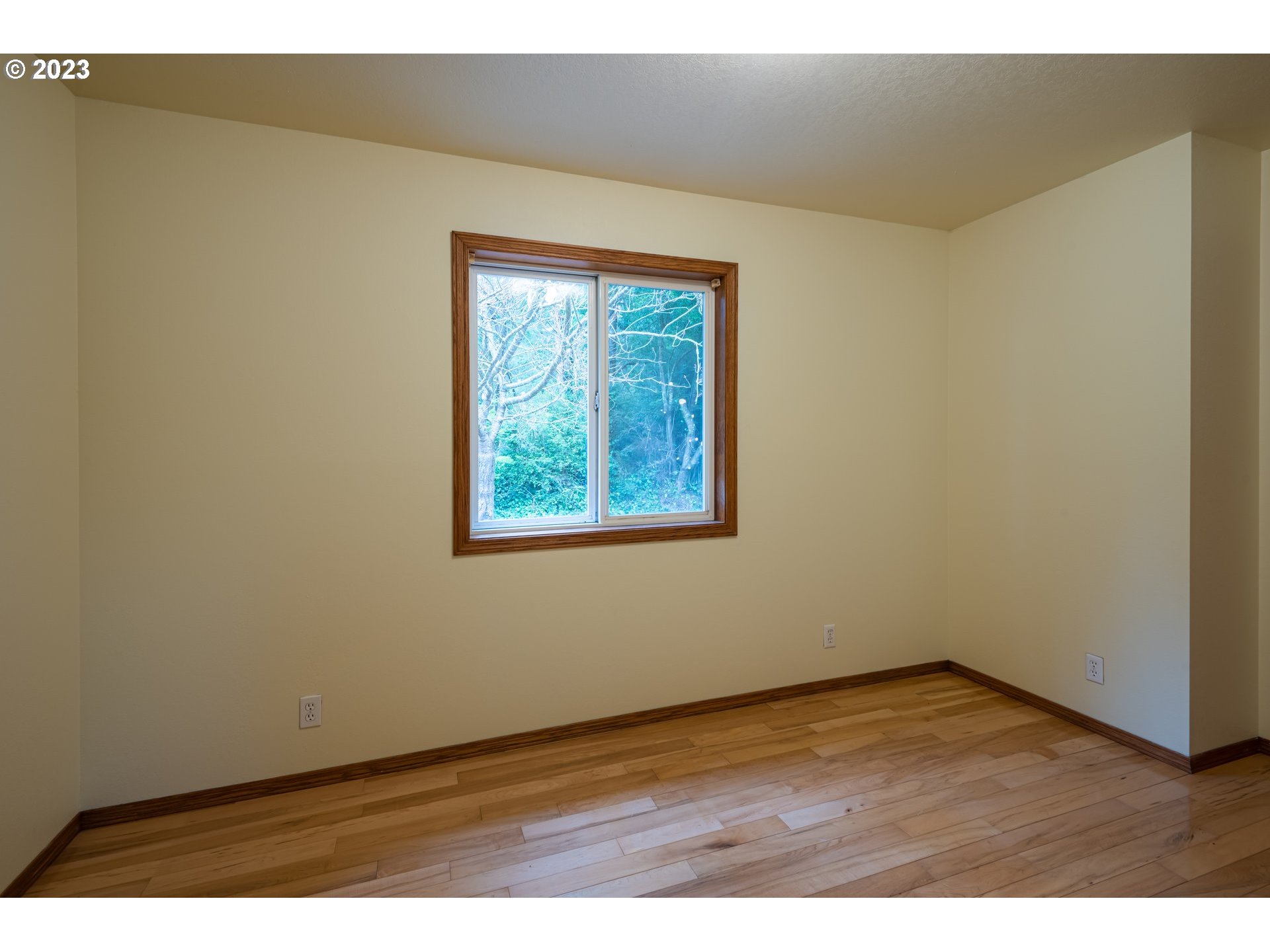 87763 Two Mile Lane Bandon, OR 97411 - Photo 24 of 41 an empty room with wooden floor and windows
