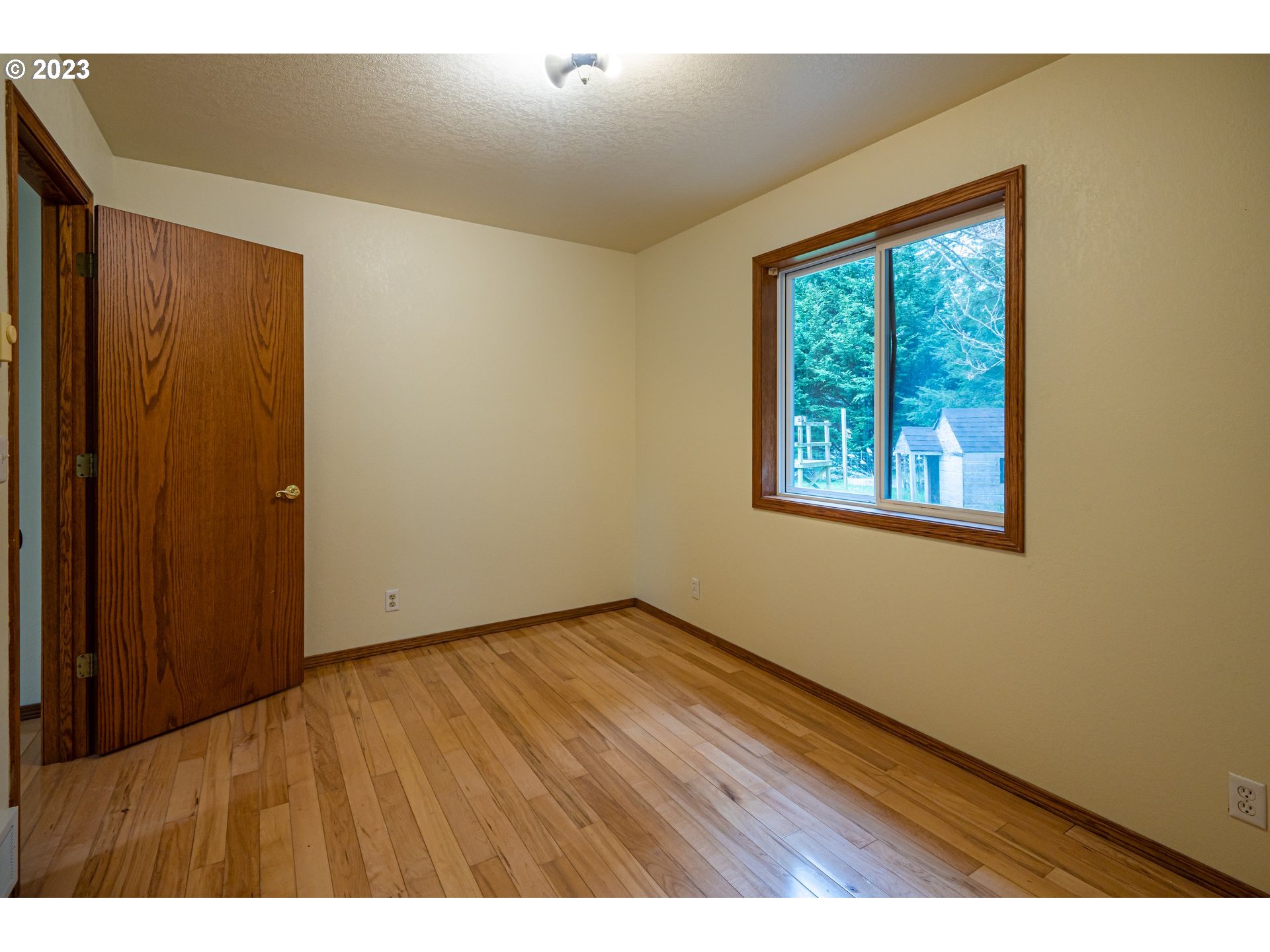 87763 Two Mile Lane Bandon, OR 97411 - Photo 25 of 41 a view of an empty room with wooden floor and a window