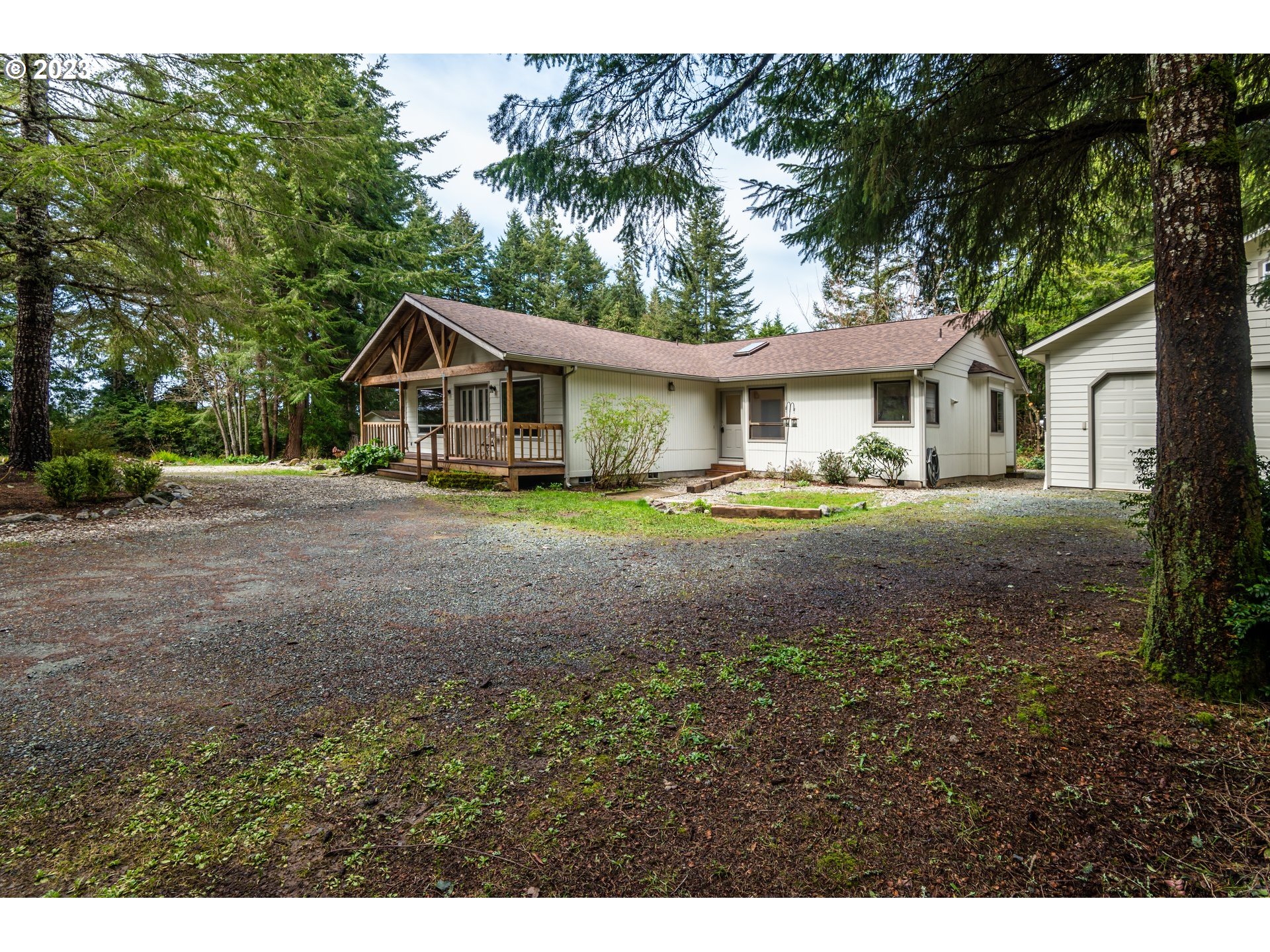 87763 Two Mile Lane Bandon, OR 97411 - Photo 3 of 41 a front view of a house with a garden