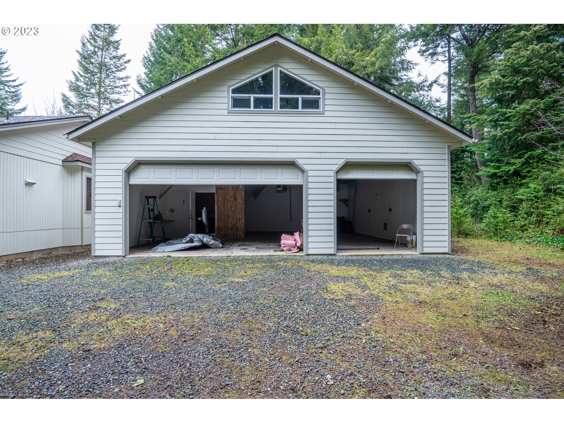 87763 Two Mile Lane Bandon, OR 97411 - Photo 32 of 41 a view of a house with a yard and garage