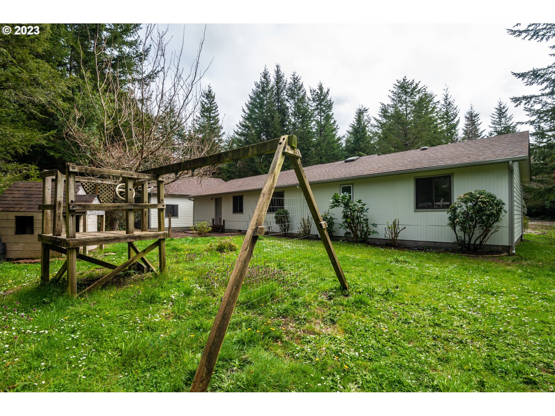 87763 Two Mile Lane Bandon, OR 97411 - Photo 37 of 41 a view of a house with backyard and a sitting area
