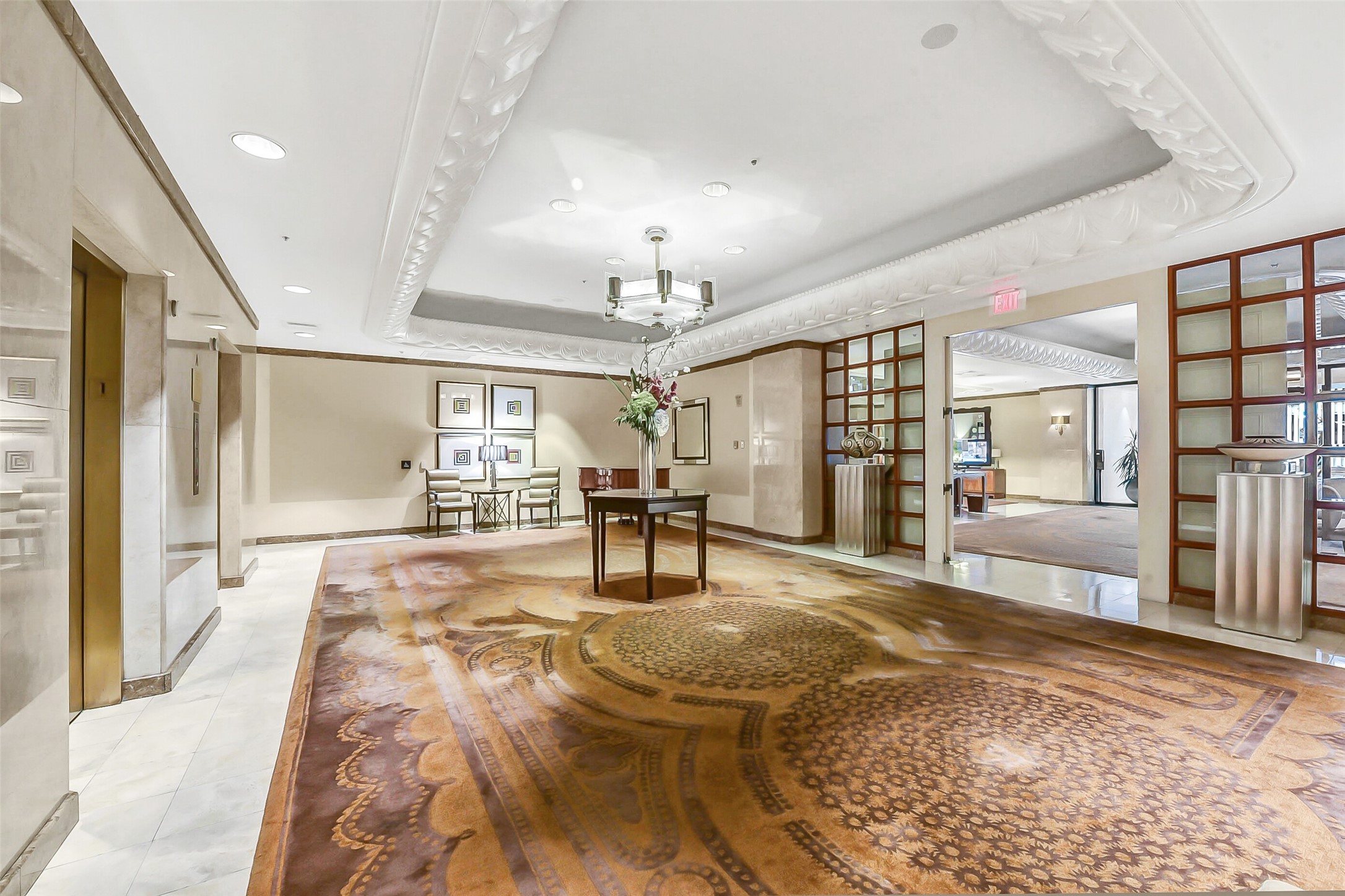1111 Caroline Street, Unit 2903 Houston, TX 77010 - Photo 25 of 27 The lobby of the Four Seasons Residences welcomes you with timeless elegance. This view showcases the polished transition toward the private elevators, anchored by a classic grand piano in the background.