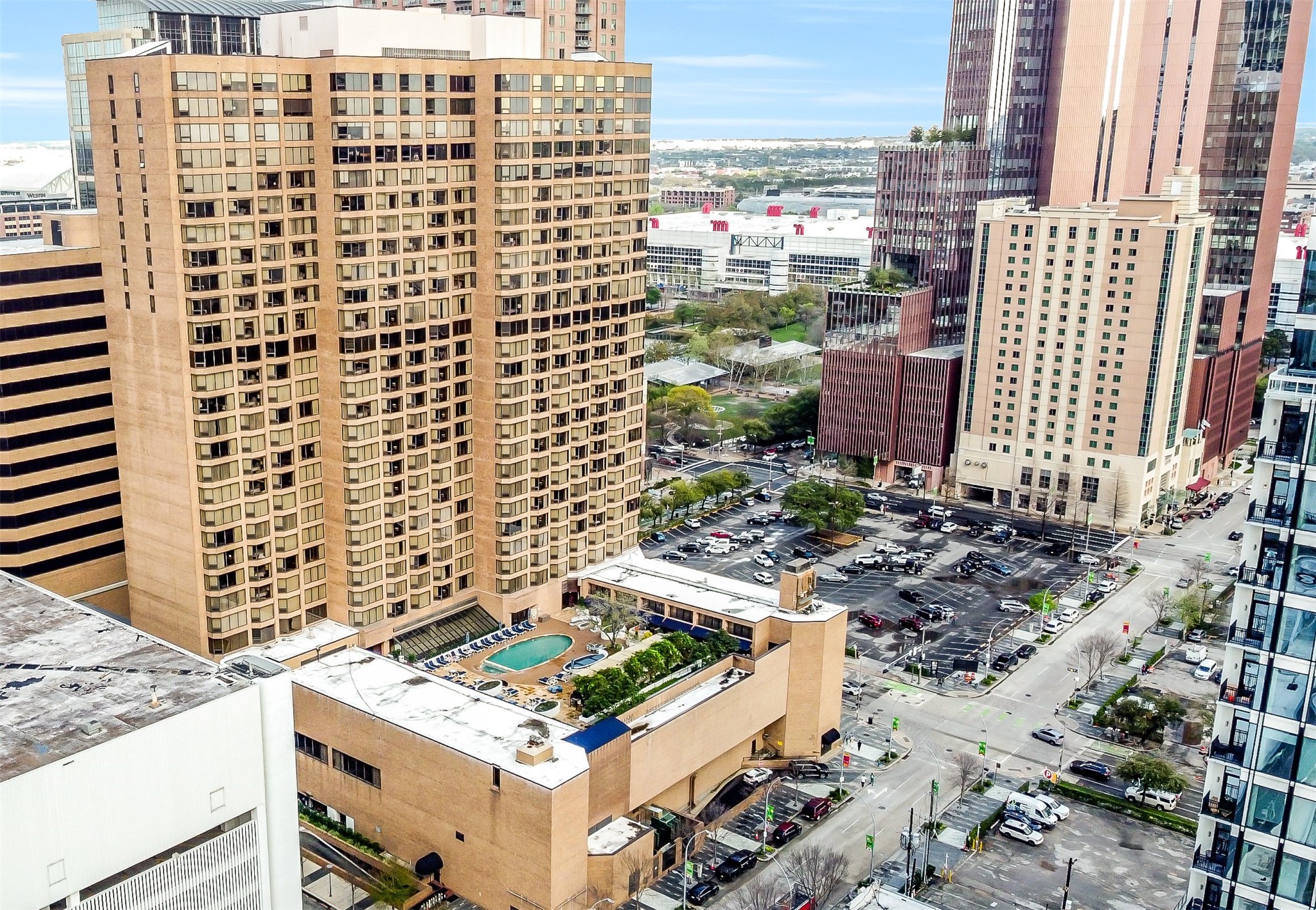 1111 Caroline Street, Unit 2903 Houston, TX 77010 - Photo 27 of 27 This aerial photo highlights the Four Seasons’ signature 4th-floor resort pool deck. Just beyond the building's footprint, you'll see the immediate proximity to the George R. Brown Convention Center and the vibrant Discovery Green park.
