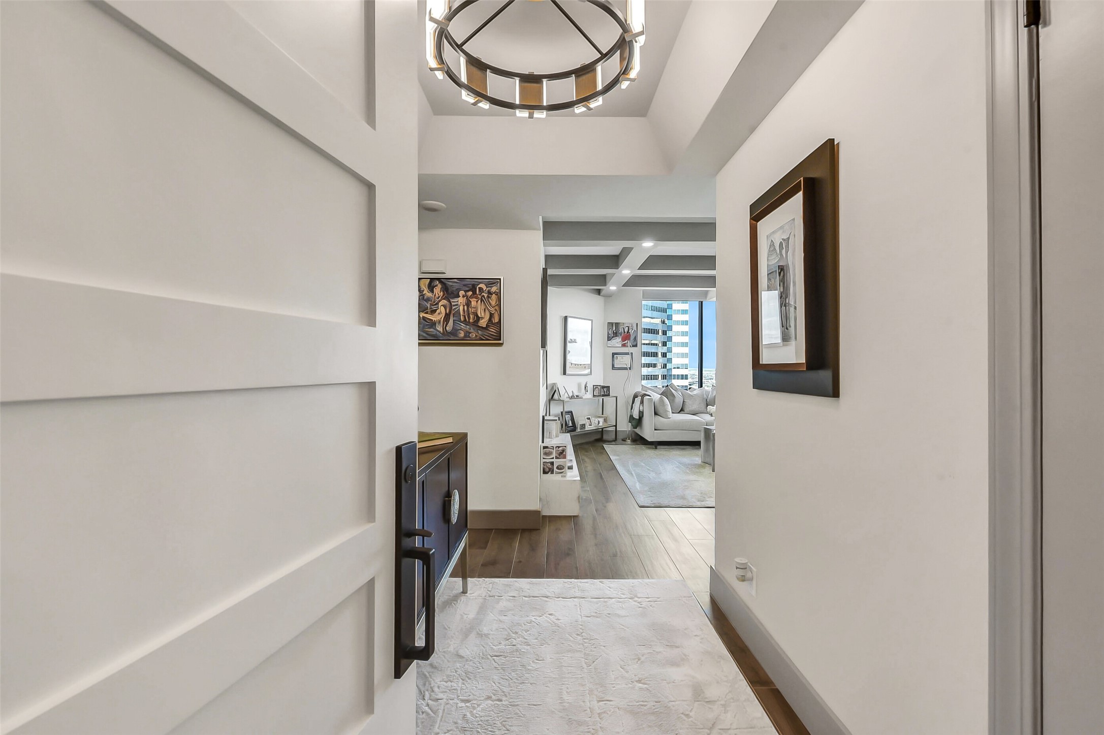 1111 Caroline Street, Unit 2903 Houston, TX 77010 - Photo 3 of 27 Step into a light-filled sanctuary. The elegant entry foyer features a neutral palette, recessed lighting, and a clean, modern design that flows seamlessly into the heart of the home.