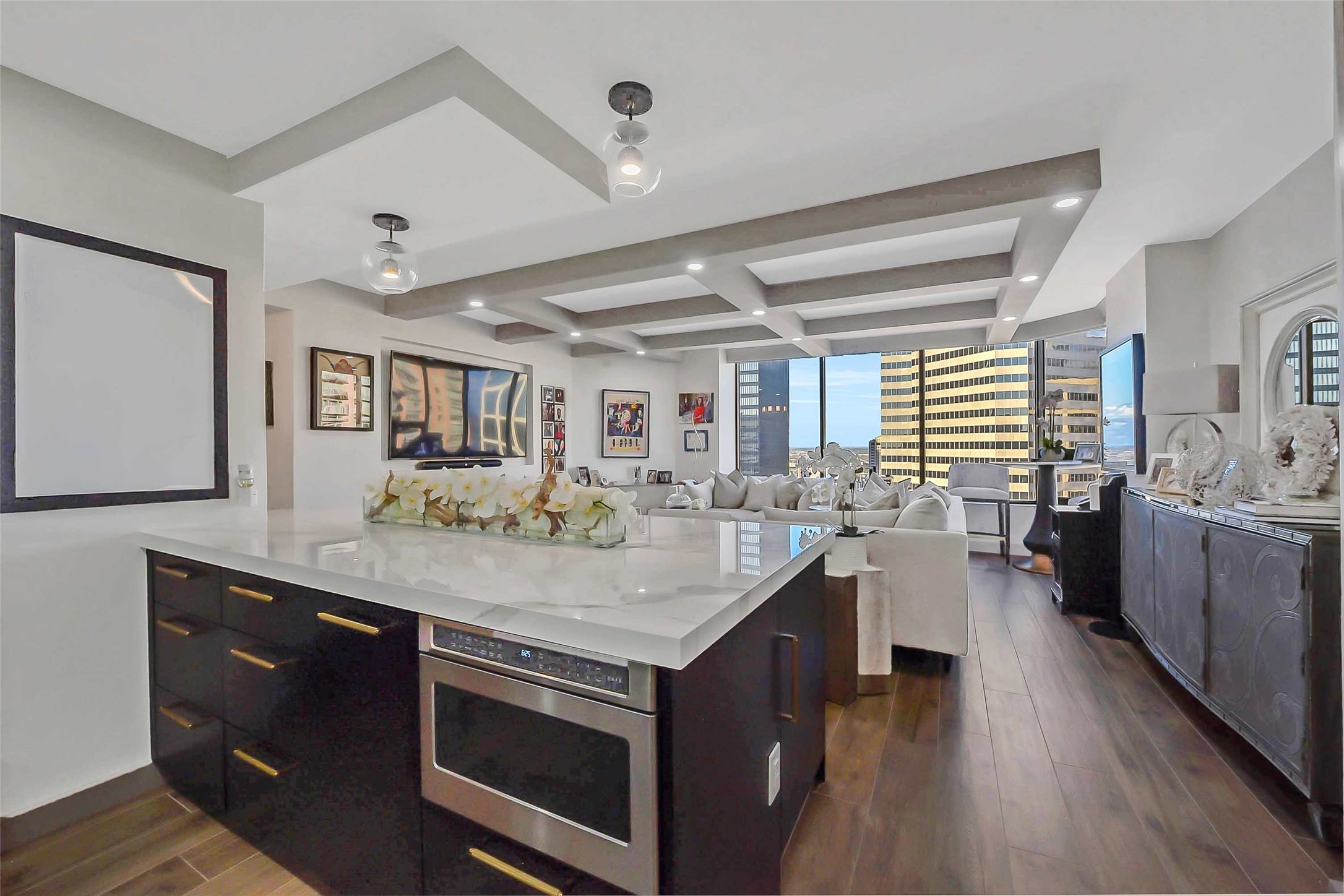 1111 Caroline Street, Unit 2903 Houston, TX 77010 - Photo 8 of 27 Designed for seamless entertaining, the gourmet kitchen opens directly into the expansive living area. This perspective highlights the home's impressive open-concept flow.