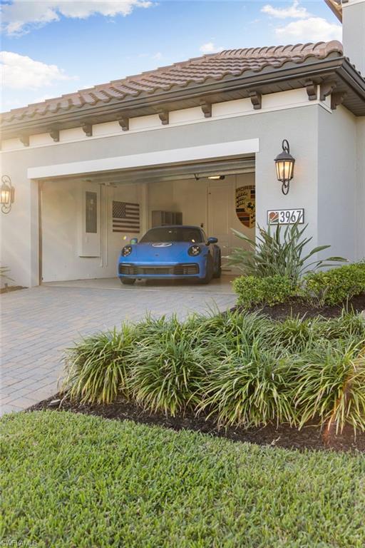 3967 Pegasus Way Naples, FL 34120 - Photo 36 of 50 a front view of a house with garden