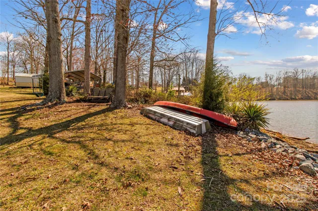 a living room with a bed furniture and a large window