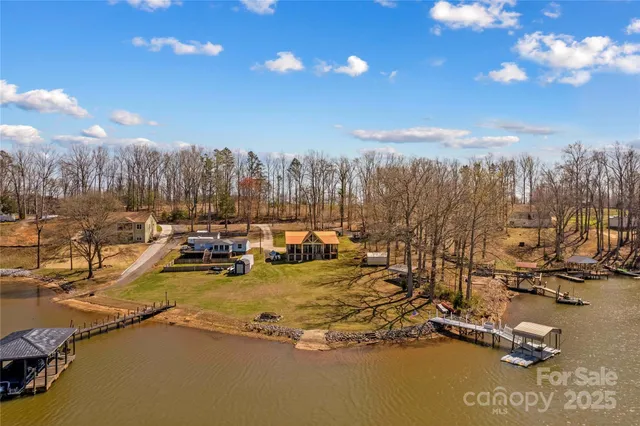 a view of an ocean with boats and trees in the background