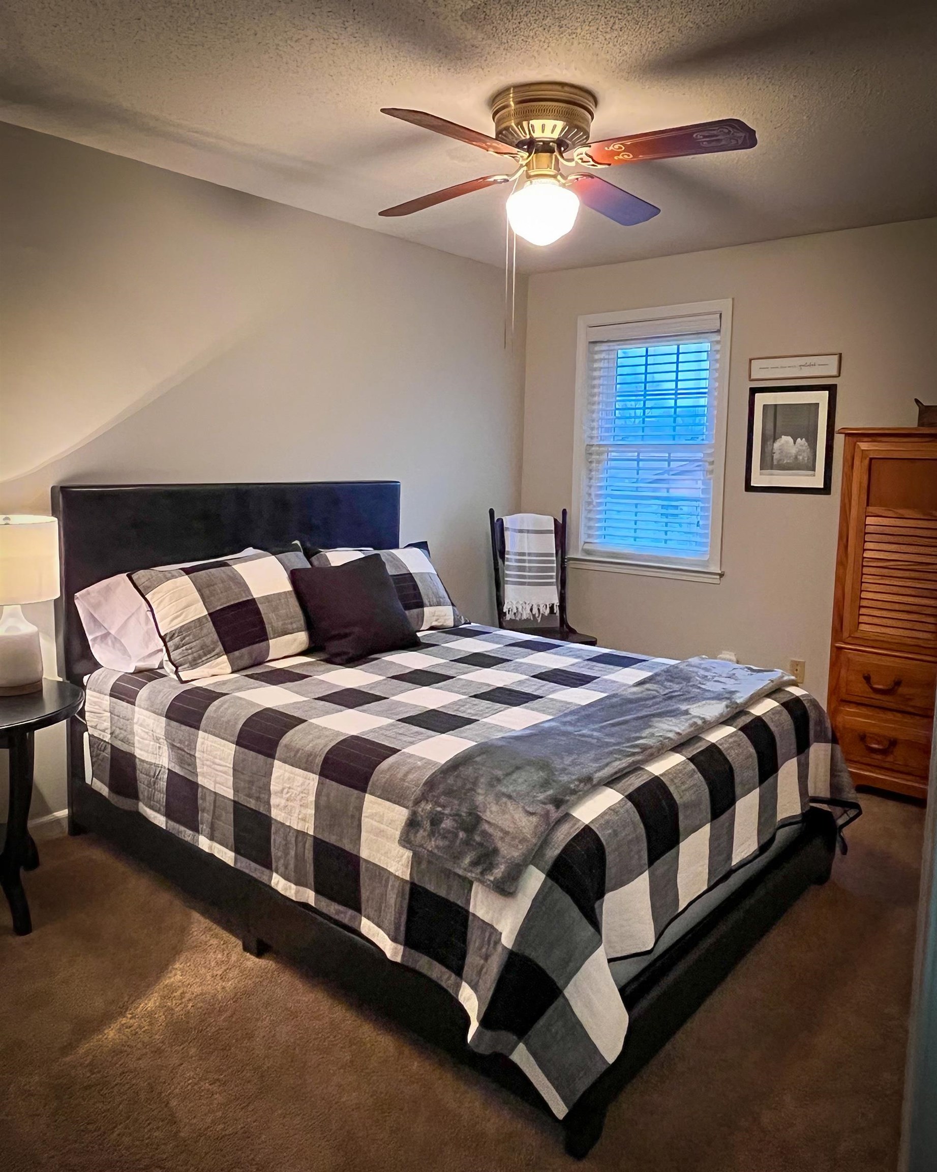 6410 Macon Road Memphis, TN 38134 - Photo 8 of 13 a bedroom with a bed lamp and a chandelier