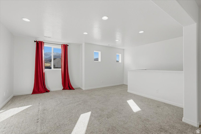 1218 Moonlight Drive Elk Ridge, UT 84651 - Photo 15 of 44 Empty room with light carpet and recessed lighting