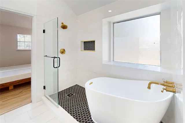 a bathroom with a bathtub and a shower