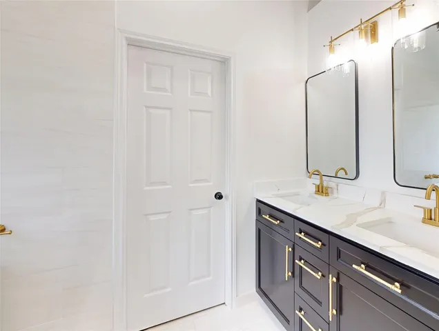 a bathroom with a double vanity sink and a mirror