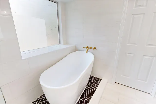 a white bath tub sitting in a bathroom