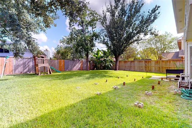 a view of swimming pool with deck and a garden