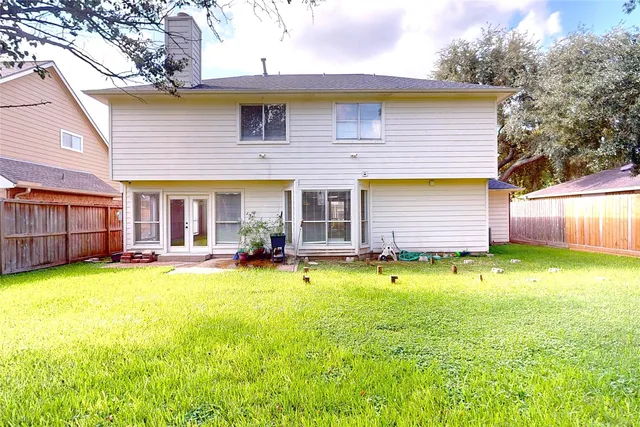 a view of a house with swimming pool and a yard