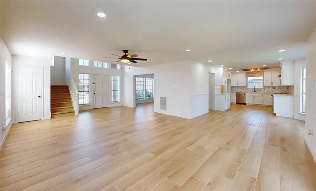 a view of a kitchen with a sink and a refrigerator