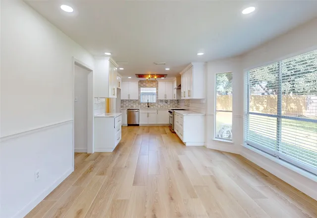 a view of a kitchen with wooden floor